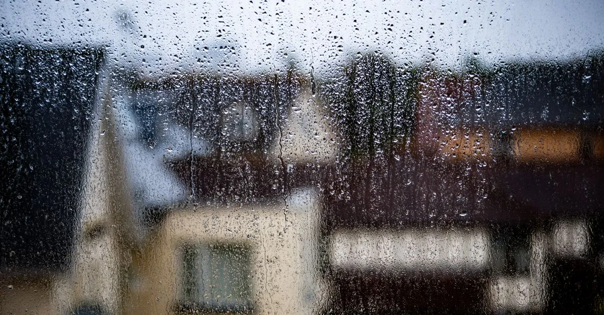 Blurred view of a rainy day in Bournemouth, capturing raindrops on a window.